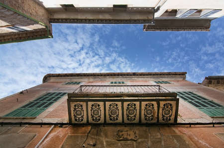 SOLLER, MALLORCA, SPAIN - OCTOBER 2, 2016: Decorated balcony low perspective on building and sky on...