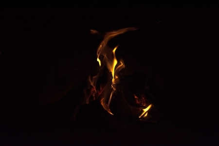 Chimney flames, fire in a chimney on dark background.
