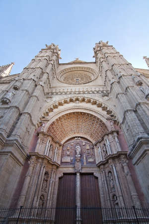PALMA, MALLORCA, SPAIN - JANUARY 17, 2017: Cathedral La Seu exterior with rosary window and towers in sunlight on January 17, 2017 in Palma, Mallorca, Spain.の写真素材
