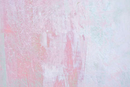Grungy red roughcast wall scratchy background texture in soft pastel baby pink and green.の写真素材
