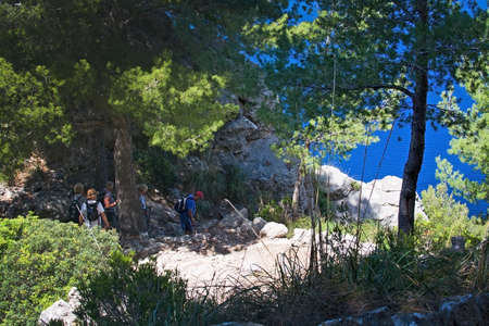 MALLORCA, SPAIN - MAY 15, 2017: People on walking path in landscape in Tramuntana mountains between Soller and Cala Tuent, on May 15, 2017 in Mallorca, Spain.のeditorial素材
