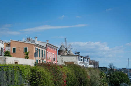 PALMA DE MALLORCA, BALEARIC ISLANDS, SPAIN - MARCH 29, 2017: Palma buildings and windmill detail in Es Jonquet area in Santa Catalina on a sunny day in December with blue sky on March 29, 2017 in Palma de Mallorca, Balearic islands, Spainのeditorial素材