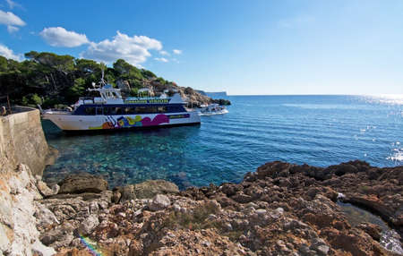 SANT ELM, MALLORCA, BALEARIC ISLANDS, SPAIN - OCTOBER 30, 2017: Ferry Margarita leaves Dragonera harbor on a sunny day on October 30, 2017 in Sant Elm, Mallorca, Balearic islands, Spain.のeditorial素材