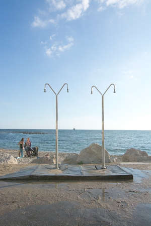 MOLINAR, MALLORCA, BALEARIC ISLANDS, SPAIN - SEPTEMBER 27, 2017: Beach showers by Molinar beach on September 27, 2017 in Mallorca, Balearic islands, Spain.のeditorial素材