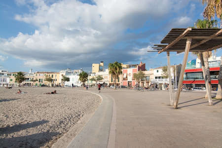 PORTIXOL, MALLORCA, BALEARIC ISLANDS, SPAIN - SEPTEMBER 27, 2017: People out and about along the promenade on a sunny day on September 27, 2017 in Portixol, Mallorca, Balearic islands, Spain.のeditorial素材