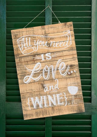 VALLDEMOSSA, MALLORCA, BALEARIC ISLANDS, SPAIN - JULY 26, 2017: All you need is love and wine sign....