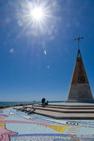 PORTIXOL/MOLINAR, MALLORCA, BALEARIC ISLANDS, SPAIN - APRIL 10, 2016: Bicyclists take a break by Molinar mosaic tower in Mallorca, Balearic islands, Spain on April 10, 2016.のeditorial素材