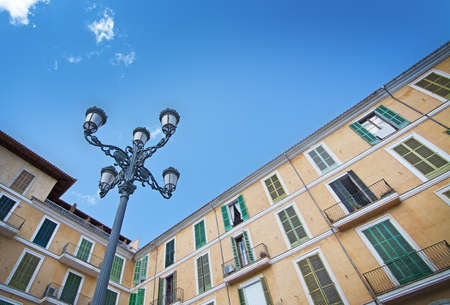 PALMA DE MALLORCA, SPAIN - SEPTEMBER 19, 2017: Buildings surrounding Plaza Mayor and blue sky on September 19, 2017 in Palma de Mallorca, Spain.のeditorial素材