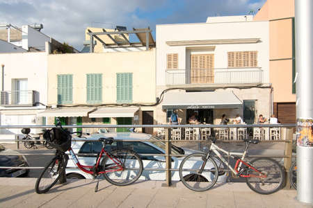 PORTIXOL, MALLORCA, BALEARIC ISLANDS, SPAIN - SEPTEMBER 27, 2017: People out and about along the promenade on a sunny day on September 27, 2017 in Portixol, Mallorca, Balearic islands, Spain.のeditorial素材