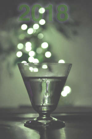 Light drink new year abstract in crystal glass background with year 2018 in new pantone colors green, purple, blueの写真素材