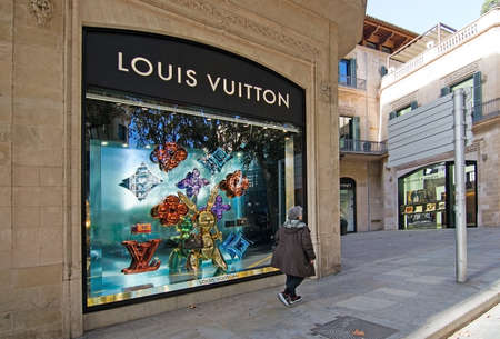 MALLORCA, BALEARIC ISLANDS, SPAIN - NOVEMBER 8 2017: Urban views Louis Vuitton store dressed for...