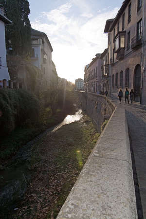 GRANADA, ANDALUCIA, SPAIN - DECEMBER 20, 2017: View along the river and Carrera del Darro on December 20, 2017 in Granada, Andalucia, Spainのeditorial素材