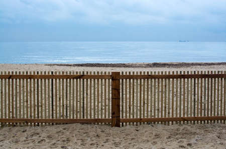 Tranquility on Mediterranean fenced winter beach in Mallorca, Balearic islands, Spain in February.の写真素材