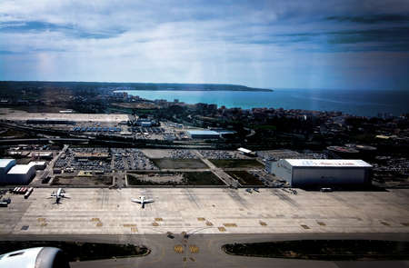 MALLORCA, BALEARIC ISLANDS, SPAIN - APRIL 14, 2016: Aerial view over Palma airport and Can Pastilla with planes on tarmac on takeoff on takeoff on April 14, 2016 in Mallorca, Balearic islands, Spain.のeditorial素材