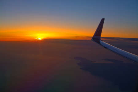 MALLORCA, SPAIN - APRIL 27, 2018: Norwegian flight image at sunrise in the ocean beyond Menorca in an early morning on April 27, 2018 in Mallorca, Spain.のeditorial素材