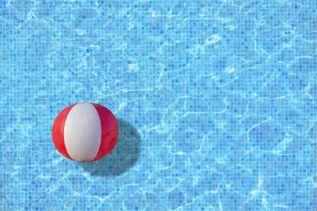 Ball in turquoise mosaic pool concept for playtime, back to work, school start for example. の写真素材