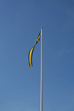 Swedish flag pennant against blue skyの写真素材