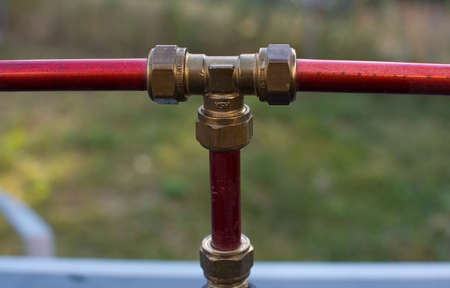 Metal plumbing water three way connector bolt outdoorsの写真素材