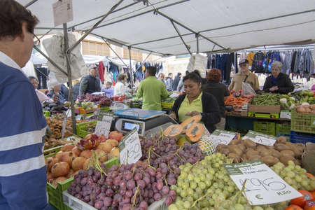 PALMA DE MALLORCA, SPAIN - DECEMBER 01, 2018: Pere Garau market vendors and buyers on December 01,...