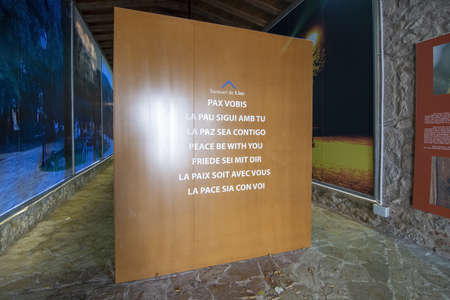 LLUC, MALLORCA, SPAIN - DECEMBER 3, 2018: Interior chapel with a board showing the text "Peace Be With You" in various languages and information on the Black Madonna on December 3, 2018 in Lluc, Mallorca, Spain.のeditorial素材