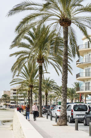 CAN PASTILLA, MALLORCA, SPAIN - NOVEMBER 23, 2018: Seaside promenade hotels with palms and people on November 23, 2018 in Palma de Mallorca, Spain.のeditorial素材