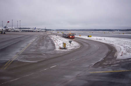 ARLANDA, SWEDEN - DECEMBER 31, 2018: Snow and ice on airport tarmac on an overcast day on December 31, 2018 at Arlanda airport, Swedenのeditorial素材