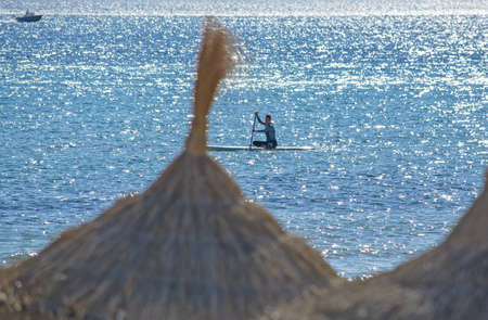 CAN PASTILLA, MALLORCA, SPAIN - DECEMBER 6, 2018: Windsurfing sails on blue Palma bay on a sunny...