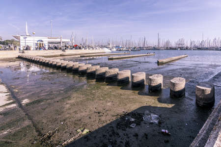 PALMA DE MALLORCA, SPAIN - FEBRUARY 9, 2019: Stepping stones over river and cafe on the other side on a sunny winter day on February 9, 2019 in Palma de Mallorca, Spain.のeditorial素材