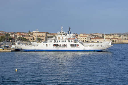 ISOLA MADDALENA, SARDINIA, ITALY - MARCH 7, 2019: Ferries moored in port in La Maddalena on a sunny...