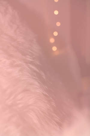 White lambswool fur and bokeh christmas lights winter concept background texture toned in Living...