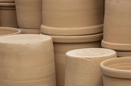 Rustic terracotta pots piled up on display closeup full frameの写真素材
