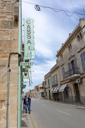 SES SALINES, MALLORCA, SPAIN - APRIL 15, 2019: Cozy Bar and restaurant Cassai exterior street view and interior details in central city on an overcast day in the beginning of tourist season on April 15, 2019 in Ses Salines, Mallorca, Spain.のeditorial素材