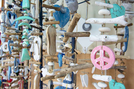 SES SALINES, MALLORCA, SPAIN - APRIL 15, 2019: Hanging decorations hearts and peace symbols street view in the beginning of tourist season on April 15, 2019 in Ses Salines, Mallorca, Spain.のeditorial素材