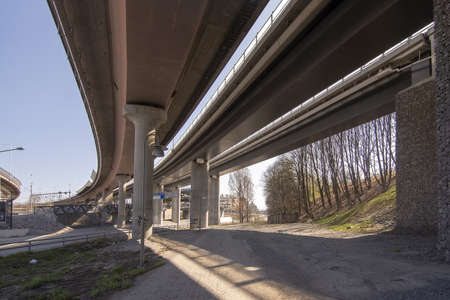 Bridge overpass with light, shadows and perspective under a trafficked lanes in central Stockholm,...