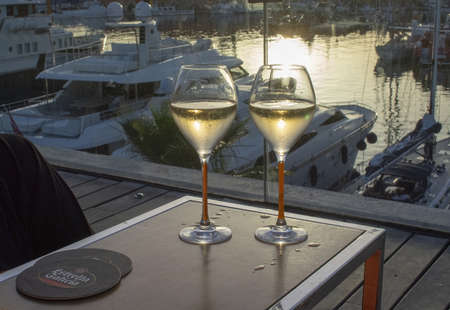 PALMA DE MALLORCA, SPAIN - JUNE 23, 2019: Two champagne flute glasses Veuve Cliquot at sunset by the marina in sunshine romantic on June 23, 2019 in Mallorca, Spain.のeditorial素材