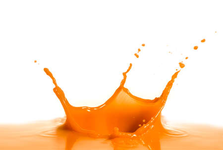 Orange wine splash isolated on whiteの写真素材