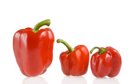 three red bell peppers on white backgroundの写真素材