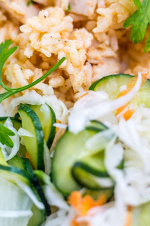 Delicious rice with pork meat and fresh cucumber  saladの写真素材