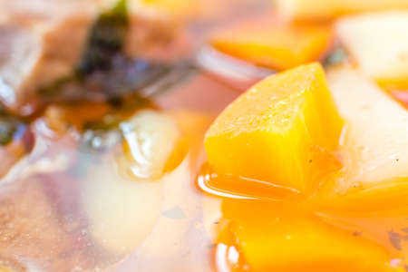 Traditional home made delicious Hungarian pork goulash soup with plenty of potato and paprikaの写真素材