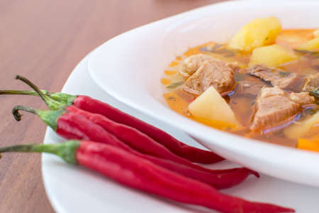 Traditional home made delicious Hungarian pork goulash soup with plenty of potato and paprikaの写真素材