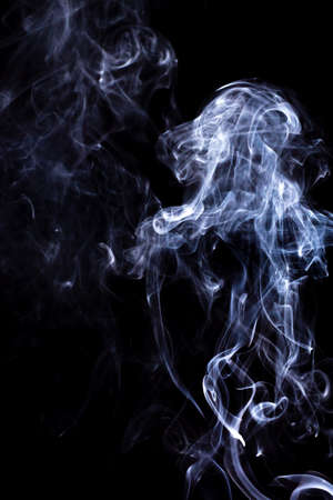 Rising smoke with different curly shapesの写真素材