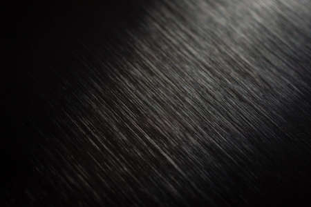 Polished metal texture with rear right illuminationの写真素材