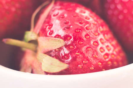 Cup of retro looking vibrant delicious strawberriesの写真素材