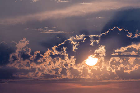 Dramatic cloudscape, sun setting through clouds