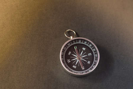 Closeup shot of a shiny metalic compass pointing always to magnetic Northの写真素材