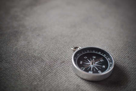 Closeup shot of a shiny metalic compass pointing always to magnetic North