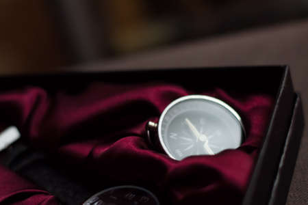 Closeup shot of a shiny metalic compass pointing always to magnetic Northの写真素材