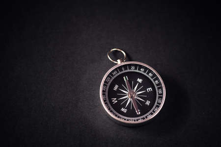 Closeup shot of a shiny metalic compass pointing always to magnetic Northの写真素材
