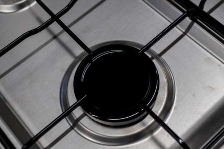 Close up shot of rapid burner on stainless steel gas hob with thin bar pan supportsの写真素材
