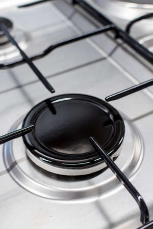 Close up shot of rapid burner on stainless steel gas hob with thin bar pan supportsの写真素材
